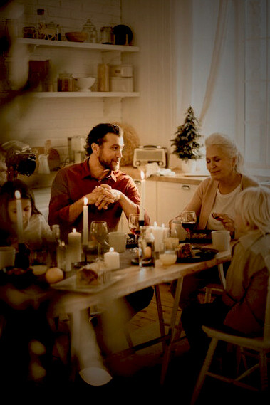 The family gathers around the table, celebrating Christmas with a delicious holiday meal