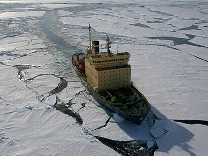 A nuclear icebreaker ship cutting through iceberg-filled waters