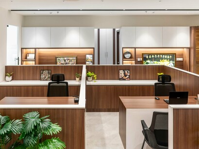 A vacant corporate workspace with equipment left in place, reflecting the organisational impact of declining headcount