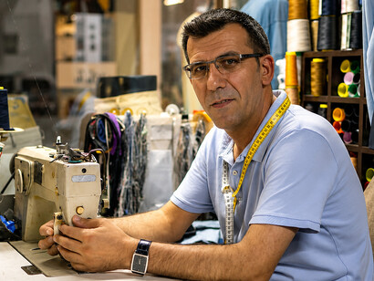 Textile artisan carefully mending clothing by hand, highlighting sustainable fashion and the art of visible repair