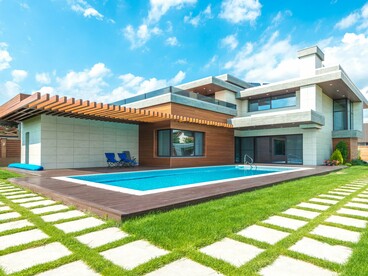 A residence layered with wood, glass and clean architectural lines, reflecting the softer, more inviting character of warm modern design