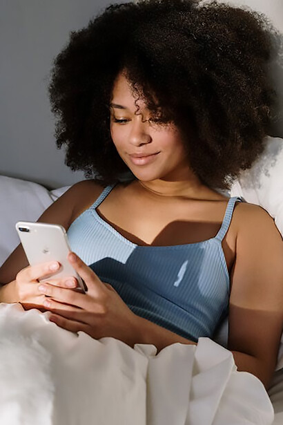 In the early hours of the morning, a young woman's routine begins with scrolling through her phone, a ritual that may be perceived by some as a less-than-optimal use of her time