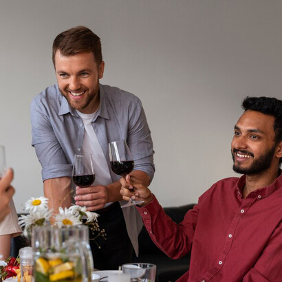 Friends come together in India for a relaxed dinner party, clinking glasses of wine and sharing stories