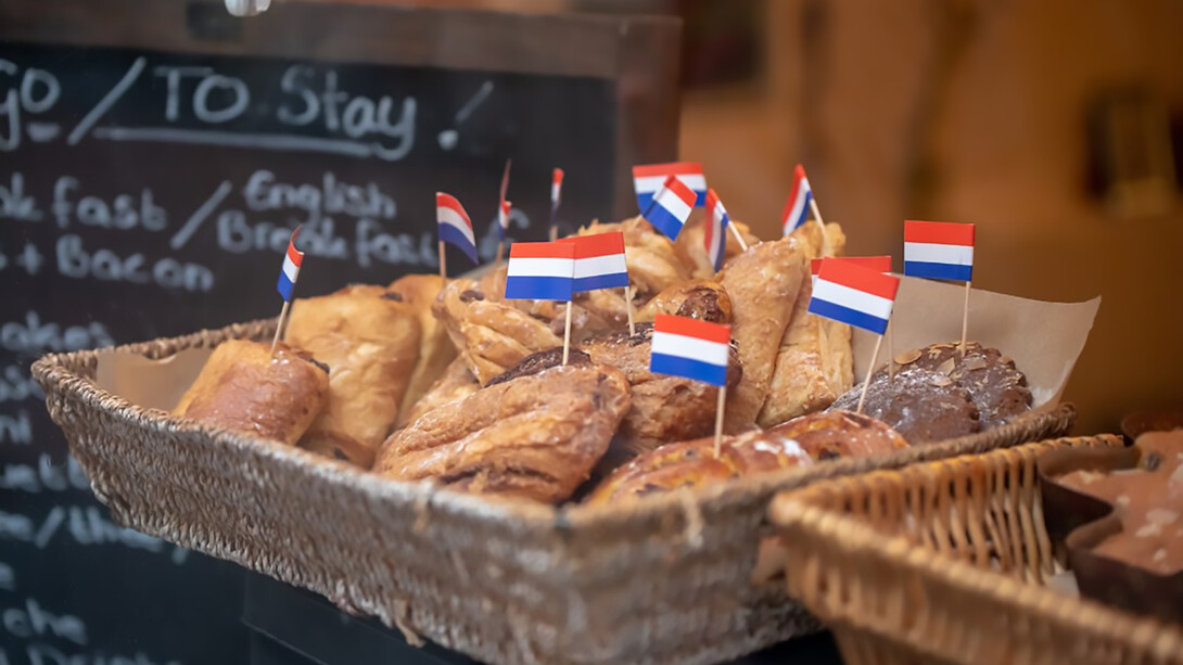 Baked pastries in a brown wicker basket, freshly prepared in Amsterdam, Netherlands