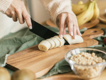 Bananas expertly chopped for Bariva, symbolizing the preservation of cultural heritage through the preparation of this beloved dish