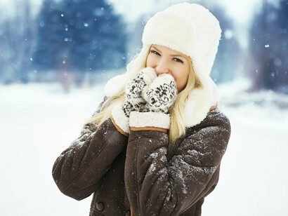 Dressed for the chill, she enjoys the season's calm, showing how winter can be more than a countdown to spring