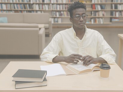 Man staring into the distance at a library
