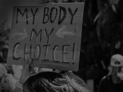 A cardboard sign reading 'my body, my choice' is referencing a woman's right to determine the decisions she makes for her own body