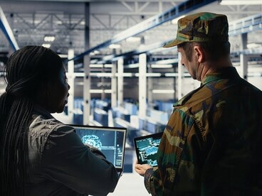 An army commander works with a software developer to operate an AI-powered radar system inside a data center