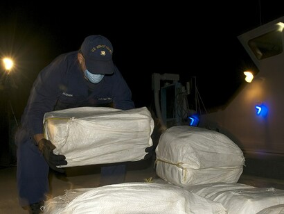 U.S. Coast Guard personnel unload cocaine seized from a Panamanian flagged vessel north of Colombia during Operation Martillo, November 2013