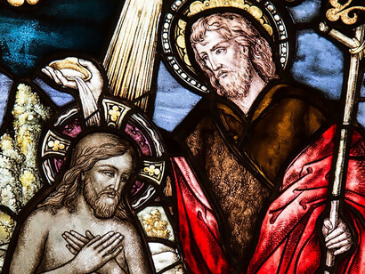 Within the church, intricate stained glass art beautifully captures the image of Jesus