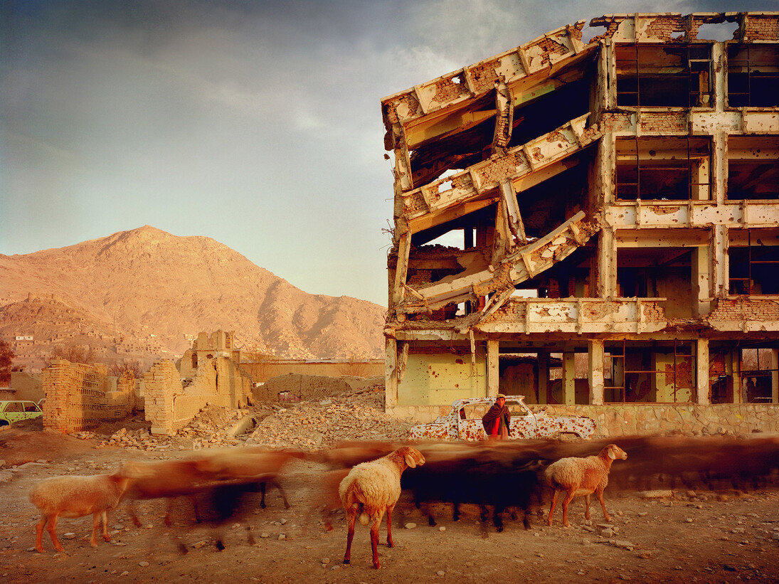 Simon Norfolk, Bullet-scarred apartment building and shops in the Karte Char district of Kabul. This area saw fighting between Hikmetyar and Rabbani and then between Rabbani and the Hazaras, 2003, © Simon Norfolk
