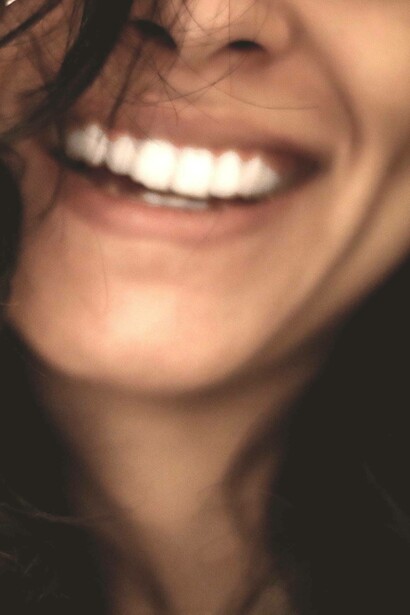 Woman smiling with her teeth out