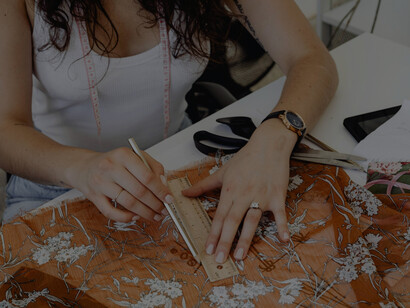 A woman creating fashion sketches as part of her clothing design process