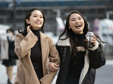Simply dressed Japanese women walking together, representing the societal inclination toward uniformity