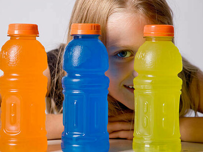 An adolescent posing with energy drinks, reflecting the issue of energy drink addiction among teens and the growing trend of youth consuming these beverages