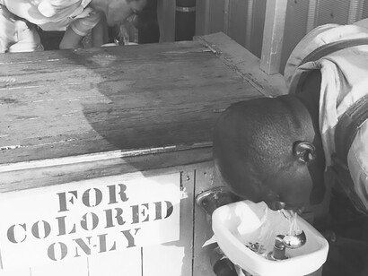 Segregated drinking fountain in use in the American South