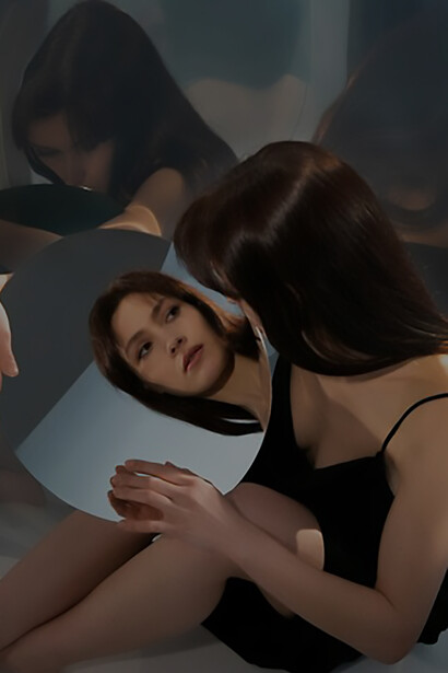 Delve into the transformative process of self-discovery and self-reflection with a striking image capturing a young woman's contemplative pose alongside her mirrored reflection, evoking themes of introspection and inner exploration