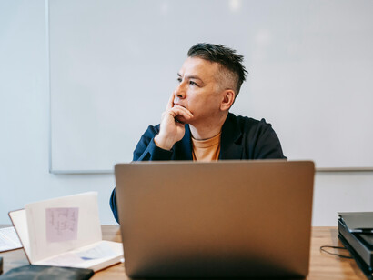 Portrait of a professional man resting his fist on his chin, lost in thought