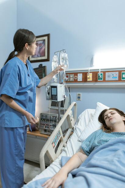A nurse checking a patient’s blood glucose level