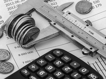 Engrossed in financial planning, the individual meticulously computes their budget using a calculator