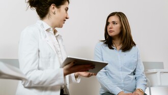 A doctor consulting their patient regarding their PCOS diagnosis