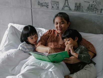 Grandmother reading cultural stories to grandchildren