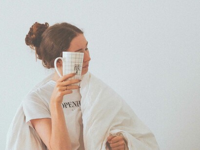 A woman dreading to let go of her duvet and wanting to remain in the comfort of her bed could be a sign of a mid mid-life crisis