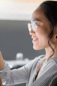 A smart home wall system, along with a smartphone, empowers a woman to monitor and control various aspects of house automation, including air conditioning and security networks