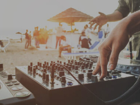 Vibrant sunset beach party with DJ and outdoor summer festivities