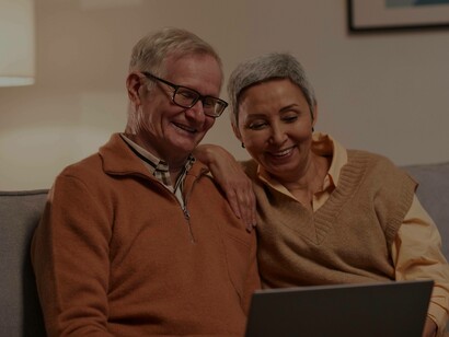 A couple smiling at their lucrative status in the silver economy