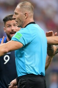 Néstor Pitana, el árbitro de la final del Mundial de Rusia, entre dos jugadores de la selección francesa
