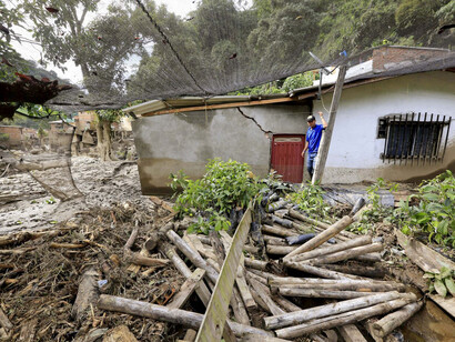 Colombia, a resident stand in front of a house destroyed during the earthquake