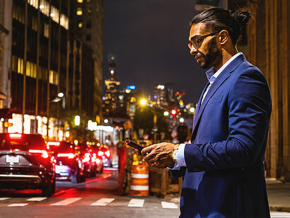 Business professionals crossing a city street in the evening financial district