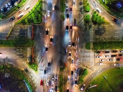 Streams of vehicles crossing a major urban junction, reflecting the continuous movement and connectivity essential to a functioning state