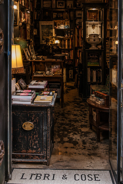 Cozy vintage bookshop filled with books, antiques, and reclaimed objects, creating a nostalgic and intimate atmosphere