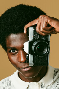 A stylish creator captures the world through his lens, much like the way Death to Stock curates visuals that connect with the cultural zeitgeist