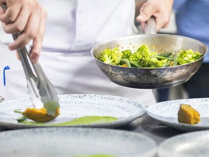 A chef prepares dishes during busy service in the kitchen of a high-end restaurant in São Paulo, Brazil