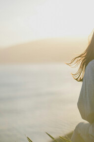 A woman by the seashore, connecting with everything around her