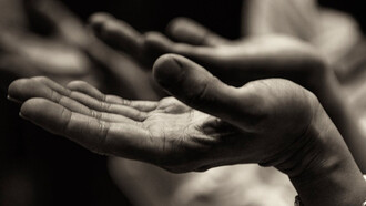 Dettaglio di mani di donne che pregano 