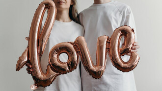 Love sign adorned with heart-shaped balloons