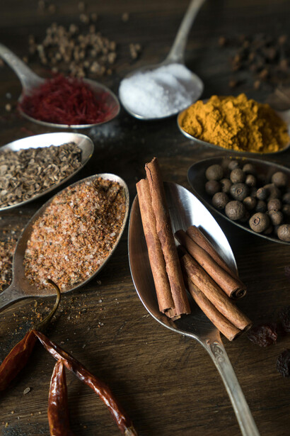 Spices and herbs on wooden spoons, reflecting Caucasian herbal remedies and traditional medicine