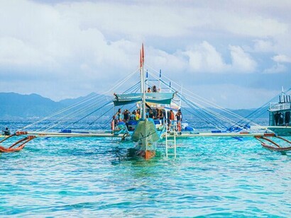 Outrigger boat surrounded by endless blue waters, reflecting stories carried across restless waves