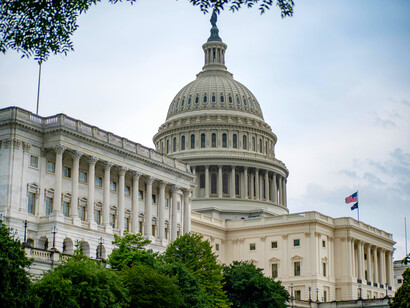 The U.S. Capitol stands beneath white clouds and a clear blue sky in Washington, D.C.