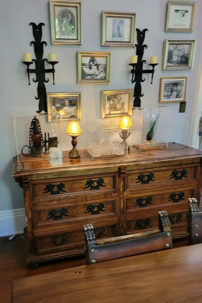 Historic furnishings and family photographs inside the Ernest Hemingway Home & Museum in Key West, Florida, representing the history of the Hemingway family on the island