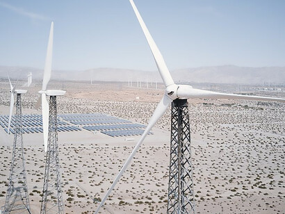 In the heart of the desert, solar panels emerge as a testament to harnessing nature's power, while wind turbines stand tall, embodying a commitment to sustainability and the pursuit of green energy solutions