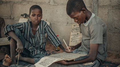 Almajiri boys engaged in learning Quranic verses and traditional education in Northern Nigeria