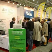 People gathering around stands at SMAU.