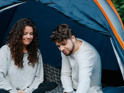 A young man and woman camping