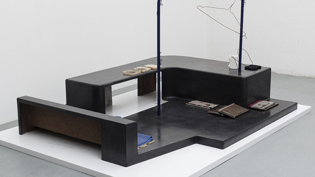 Magali Reus, In Place Of (Sundries), 2015. Black waxed and clear waxed Jesmonite, black waxed polyester resin, silicone rubber, polyurethane rubber, latex, powder coated laser cut steel, phosphated and powder coated steel, steel rod, magnets, sanded paper, polyurethane plastic, fabric, air brushed polyester resin, polyurethane resin, putty wax, vinyl. Part 1: 141 x 188 x 90 cm 